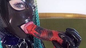 Miss Maskerade Latex doll blowjob dildo in full rubber and hood. - hdzog.com