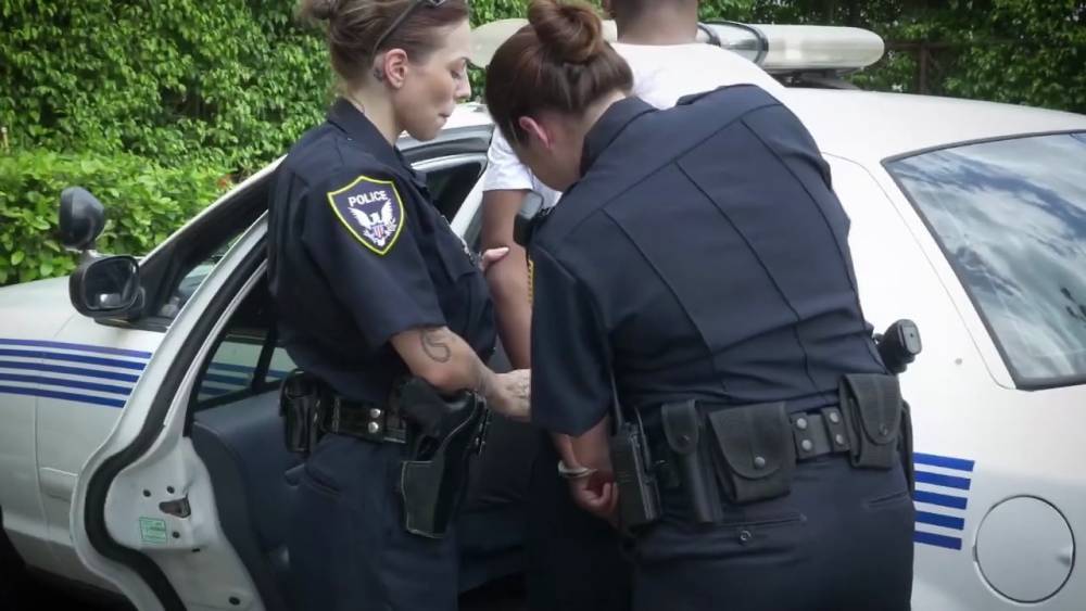 A black suspect is apprehended by two beautiful MILFs with big boobs. - gotporn.com