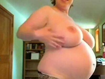Pregnant women with big tits fucks herself standing - drtuber.com