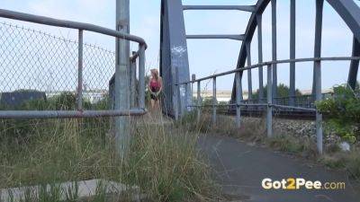 Watch this kinky European teen relieve herself near a railway track - sexu.com