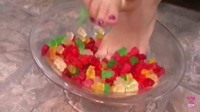 A Kinky Brunette Sticks Her Feet In Gummy Bears And Performs A Footjob Until Cumshot - hotmovs.com