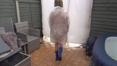 Under Plastic Transparent Raincoat And Wellingtons Out In The Cold Outdoors - hclips.com