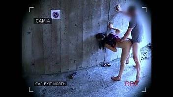 Young couple fucks in front of the garage exit and is caught by the surveillance camera - xvideos.com